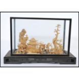 A large 20th century Japanese cork diorama model of a traditional Japanese scene with pagodas, trees