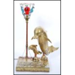 An unusual vintage seahorse and dolphin lamp of brass construction having a relief brass scene