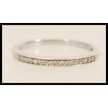 A hallmarked 9ct white gold ring set with diamond accent stones. Hallmarked Sheffield. Weight 2.