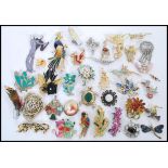 A good selection of vintage  costume jewellery brooches to include rhinestone floral brooches, a