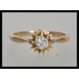 A stamped 9ct gold ring set with a brilliant cut with stone in a star setting. Weight 1.5g. Size J.