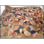 A vintage early 20th century patchwork throw / blanket / bed cover, constructed from various