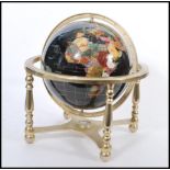 A vintage 20th century large terrestrial globe having semi precious stone inlay. Black stone