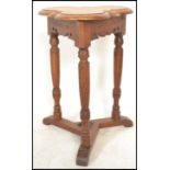 A 19th century Victorian Arts & Crafts oak lamp table having turned tapering legs with splayed