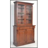 A Victorian 19th century mahogany library bookcase cabinet. Raised on a plinth base with double door