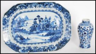 An 18th Century ceramic tray hand painted in a blue and white pattern with a landscape scene to