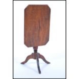A 19th Century miniature large scale dolls house mahogany tilt top table raised on a central