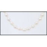 A Baroque pearl necklace with a stamped 375 9ct gold clasp in a Guernsey Pearl box. Measures 18