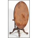 A Victorian mahogany oval breakfast tilt top dining table raised on a pedestal support with tilt