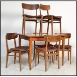 A vintage mid 20th Century teak wood extending Danish influence dining room suite comprising a
