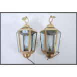 A pair of 20th century brass porch lanterns, each of tapering hexagonal form with clear glass panels