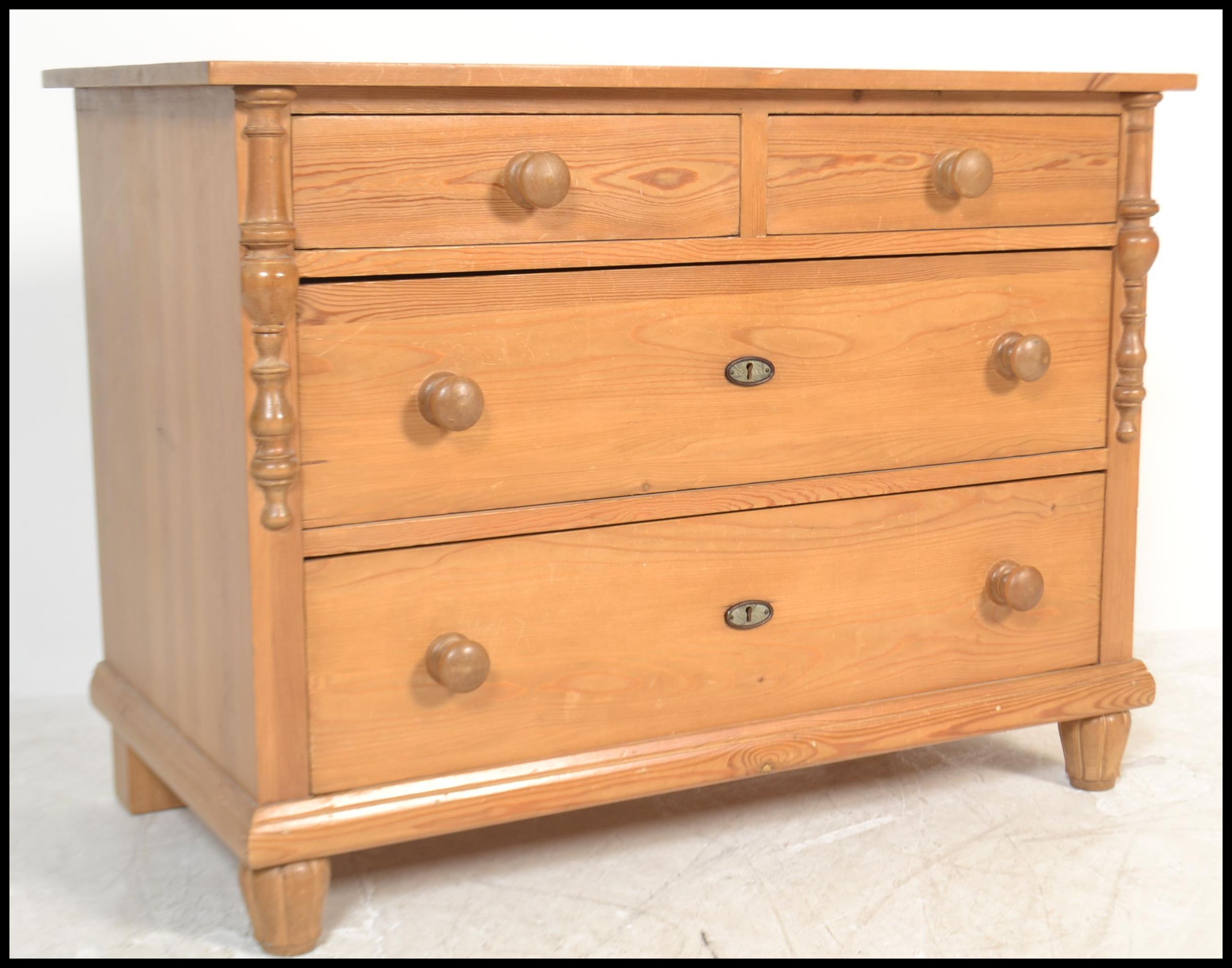 An antique style Scandinavian pine chest of drawers having 2 short and 2 deep drawers with flared