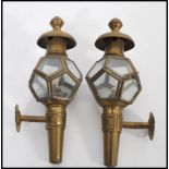 A pair of 19th Century Victorian brass carriage lamps having glazed pentagonal windows with finial