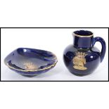 A porcelain miniature jug having a royal blue glaze with a gilt crest of the Order of the