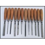 A set of twelve vintage woodworkers Chisels by Addis, all the chisels of differing size and shape