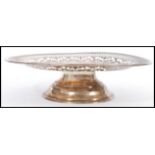 A stamped 925 silver cake stand / tazza with pierced decoration to the plate. Weight 273g.