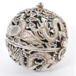 A Chinese silver pierced incense ball having decoration of dragons flames and birds with silver