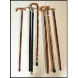 A group of vintage walking stick canes to include horn handled example, one with place crests,