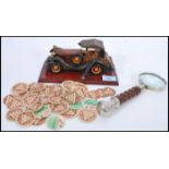 A 20th Century carved wood model of a 1920's soft top car with a varnished finish on a plinth