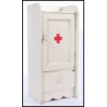 An early 20th Century wall hanging medicine cabinet / First Aid box, the hinged door opening to