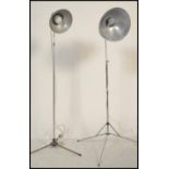 Two vintage retro 20th century telescopic adjustable photographic lamps raised on brushed steel