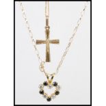 Two 9ct gold necklaces to include a crucifix pendant with a spring ring clasp, and a heart pendant