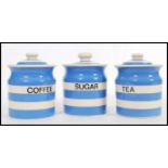 A trio of vintage 20th Century blue and white hooped lidded storage jars in the manner of TG
