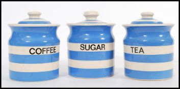 A trio of vintage 20th Century blue and white hooped lidded storage jars in the manner of TG