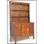 A vintage early 20th century country oak Welsh dresser base having a configuration of drawers and