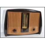 A vintage retro early / mid 20th Century bakelite valve radio by GEC with a labelled dial Medium and