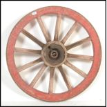 A 19th century wrought iron bound cartwheel of typical from having central iron wheel mount with