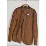 A gentleman's fashion brown leather suede quilted jacket by Blue Harbour having a corduroy collar,