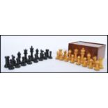 A vintage early 20th century boxwood and ebony chess set complete in sliding chess box.