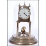 Mid 20th Century brass anniversary or torsion clock having a white face with arabic numerals to