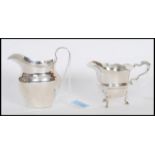 Two silver hallmarked cream jugs by George Nathan & Ridley Hayes to include one on pad feet with a