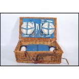 A good quality picnic hamper set to the original wooden wicker basket having leather straps.