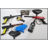 A group of paint balling equipment to include Paradox gun, Piranha Field Marker gun, PMI gun,