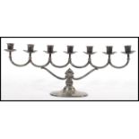 A silver hallmarked 20th Century Danish / Norway 830S menorah, with scrolled branches raised on a
