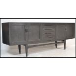 A G plan fresco pattern teak wood sideboard credenza having a bank of drawers to centre flanked by