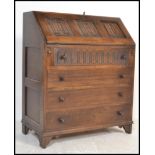 A Jaycee / Old Charm style oak bureau desk with linen fold decoration to the bureau with bank of