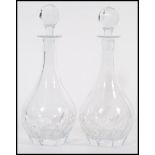 A pair of vintage 20th century cut glass crystal leaded decanters having faceted bulbous bodies with