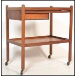 A vintage mid 20th Century teak wood two tiered buffet / drinks trolley, single drawer fitted to the