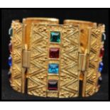 A vintage signed Sphinx Egyptian revival gold-tone bracelet set with square cut coloured glass