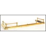 A 19th century Victorian brass adjustable kerb fire fender guard having metamorphic action and