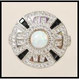 A stamped 925 silver Art Deco style ring with a round head set with a central opal and surrounded by