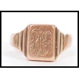 A hallmarked 9ct gold gents signet ring having a monogrammed cartouche and stepped shoulders. Weighs