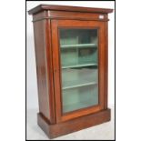 An Edwardian mahogany pier - display cabinet. Of pedestal form being raised on a plinth base with