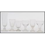 A group of six antique Georgian early 19th century drinking glasses to include a very tall example