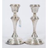 A pair of 20th century silver hallmarked candlesticks raised on circular bases with knopped stems