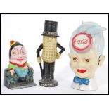 A collection of vintage 20th Century retro cast iron money boxes of advertising interest to